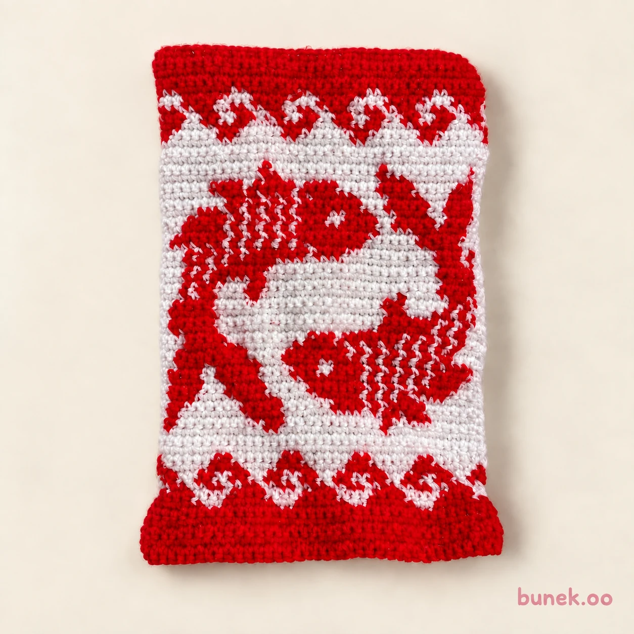 Red and cream rectangular crochet tapestry depicting two koi fish