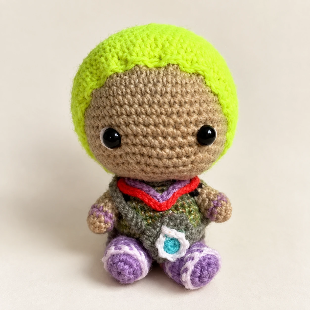 Gekko crochet doll with lime-green hair, purple shoes and a green outfit